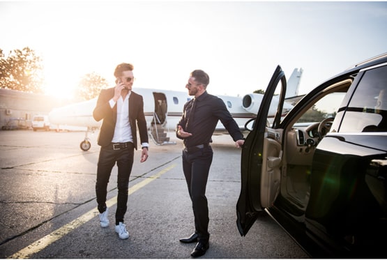 Business professionals with luxury car